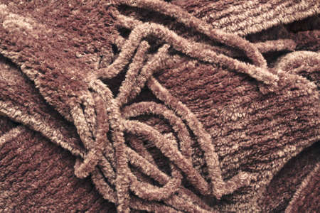 Close up of the tassles of a brown winter scarfの写真素材