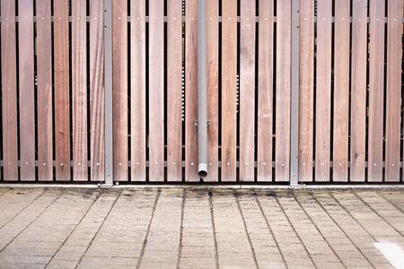 Modern fence with a drain pipe as a backgroundの写真素材