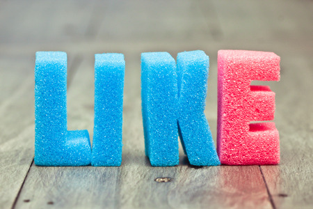 Like in foam letters on a wooden surfaceの写真素材