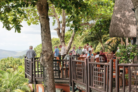 MAURITIUS â NOVEMBER 21, 2013: Tourist groups relax on the wooden balcony at Le Chamarel Restaurant in Mauritius.のeditorial素材