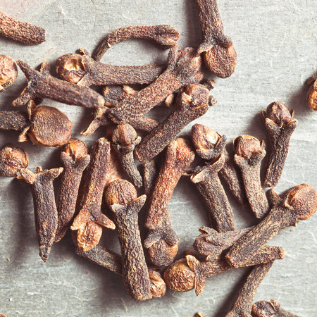 Close up of clove seeds on a stone surface