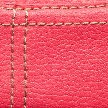 Macro of pink stitched leather as a backgroundの写真素材