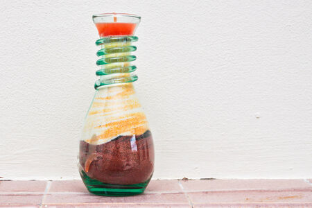 Colorful souvenir candle in a glass vase