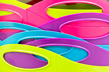 Close up of the handles of colorful plastic tubsの写真素材