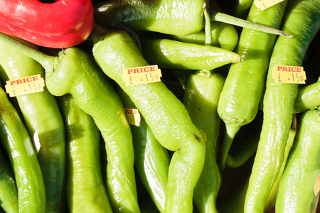 Fresh green jalapeno peppers at a UK market stall with prices