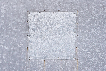 Metal plate with rusty nails as a background