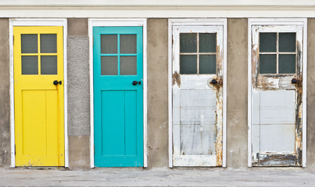 Colorful and weathered wooden doors in a rowの写真素材