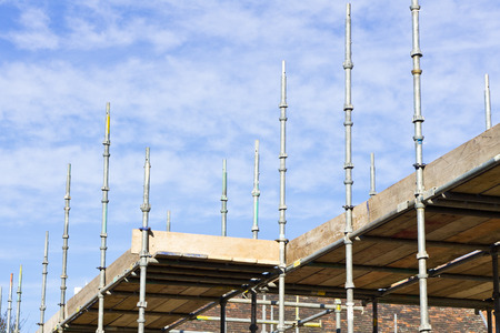 Scaffolding at a construction site against a blue sky