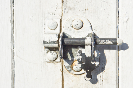 Close up of a lock on a white gateの写真素材
