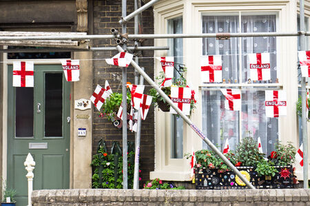 BURY ST EDMUNDS, UK- JUNE 15 2014- Flags outside a house in Bury St Edmunds, indicating support for the England football team in the world cup 2014.のeditorial素材