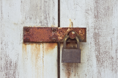A padlock on a rusty latchの写真素材
