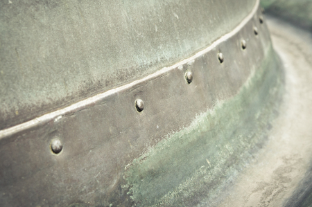Close up of part of a metal container with boltsの写真素材