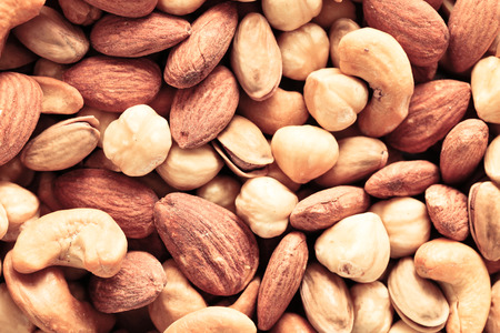 Mixed roasted salted nuts as a detailed background