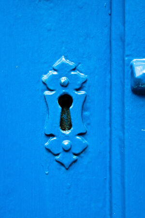 A blue keyhole in a doorの写真素材