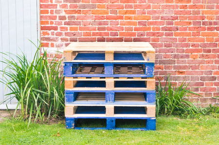 Stack of wooden pallets in a gardenの写真素材