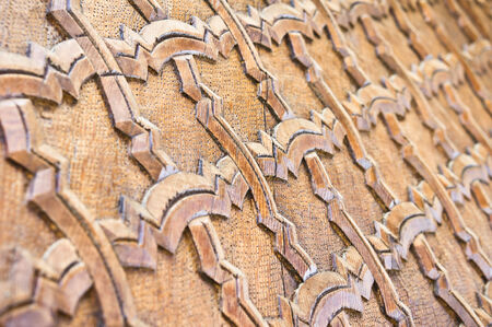 Islamic pattern carvied into wood on a door in Morocco