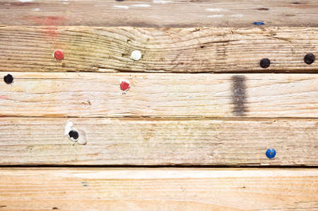 Pile of wooden planks with drawing pins in themの写真素材