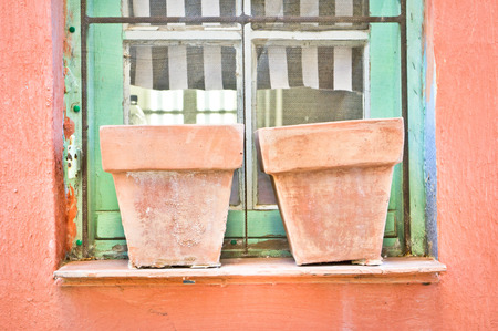 Two empty clay pots on a window sillの写真素材
