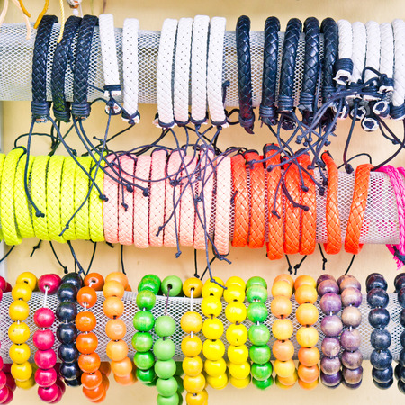 Colorful souvenir bracelets on sale at a marketの写真素材