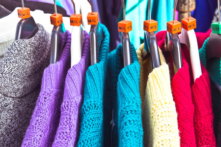 Selection of colorful wool tops at a market stallの写真素材
