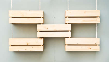 Five wooden display crates hanging on a wall