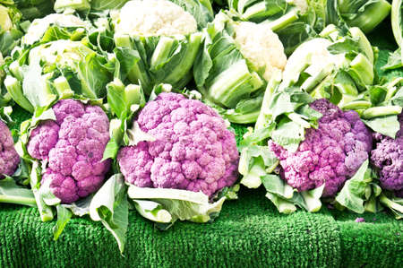 Purple cauliflowers on sale at a market stallの写真素材