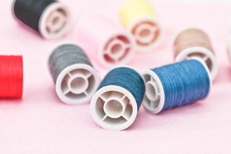 Reels of cotton on a felt pink surfaceの写真素材