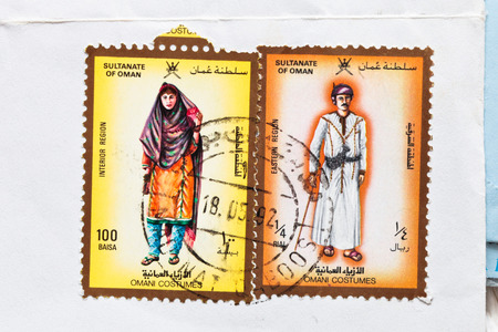 BURY ST EDMUNDS, UK- OCTOBER 15 2014:  Two Omani postage stamps from 1992 on a white envelopeのeditorial素材