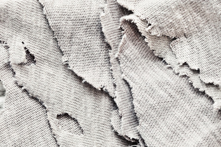 Torn fabric as a backgroundの写真素材
