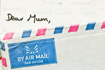 Corner of an airmail envelope with a letter addressed to Mumの写真素材