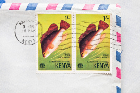 BURY ST EDMUNDS, UK- OCTOBER 15 2014:  Two Kenyan postage stamps from 1977 on an airmail envelopeのeditorial素材