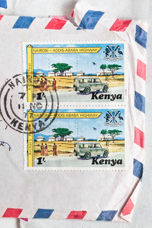BURY ST EDMUNDS, UK- OCTOBER 15 2014:  Two Kenyan postage stamps from 1977 on an airmail envelopeのeditorial素材