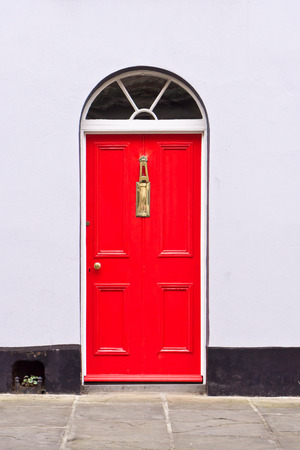 Red front door in an english town houseの写真素材