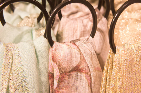 Close up of women's scarves hanging in a storeの写真素材