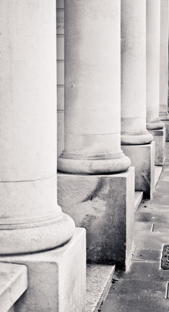 Row of stone pillars on the ouside of an urban buildingの写真素材