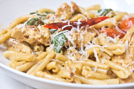 Fresh italian pasta dish with chicken and tomatoesの写真素材