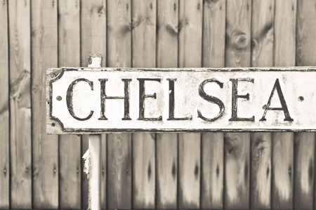 Chelsea road sign in front of a wooden fence in sepia tonesの写真素材