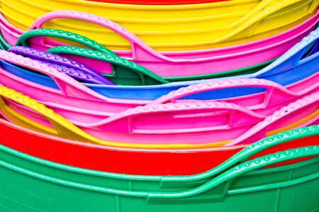 Colorful plastic tubs stacked as a background imageの写真素材
