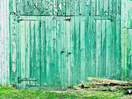 A green wooden barn wall and door in Englandの写真素材