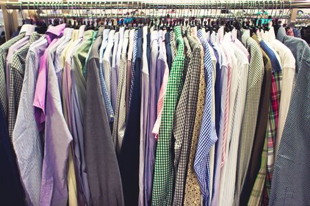 Selection of casual men's shirts on a clothing rack