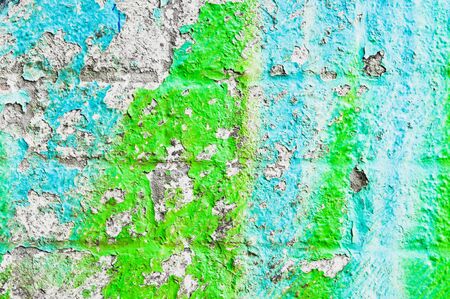 Peeling paint on a weathered brick wallの写真素材