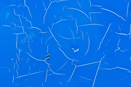 Scratched blue paint on a metal surface as an abstract imageの写真素材