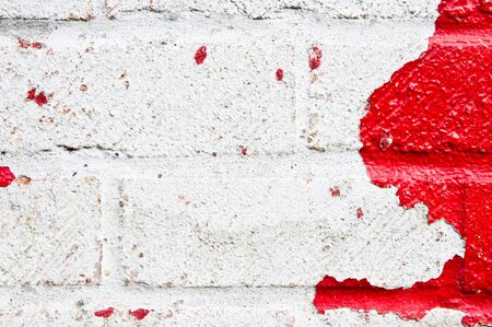 Peeling paint on a weathered brick wallの写真素材