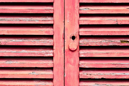 Part of a pair of red wooden doorsの写真素材