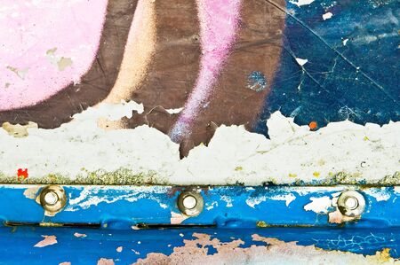 Part of a metal surface with bolts, showing peeling paintの写真素材