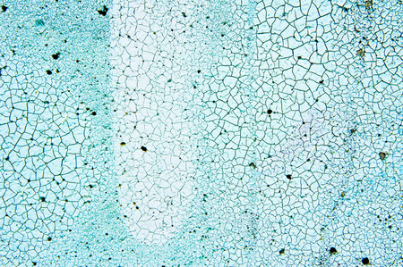 Cracked blue paint on a stone surface as a background imageの写真素材