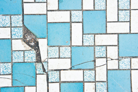 Part of a tiled surface with a crackの写真素材