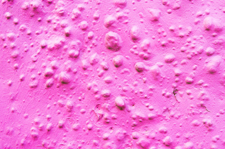 Part of a purple painted stone wall as a texture background