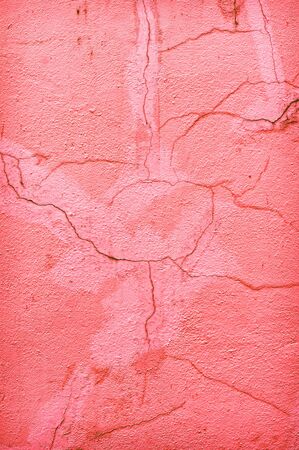 Cracks in a pink painted stone wallの写真素材