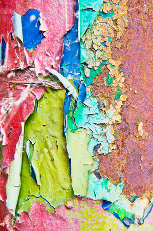 Colorful cracked paint on a metal surface, as a backgroundの写真素材